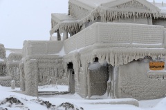HAMBURG, NY - DECEMBER 27: Homes are covered with ice after being battered with waves from Lake Erie along Hoover Beach on December 27, 2022 in Hamburg, New York. The historic winter storm Elliott dumped up to four feet of snow on the area leaving thousands without power and twenty eight confirmed dead in the city of Buffalo and the surrounding suburbs. (Photo by John Normile/Getty Images)