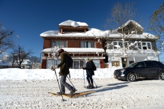 Buffalo, NY - November 20: Megan Barr and Amanda Johnston snowshoe through snow covered streets after an intense lake-effect snowstorm that impacted the area on November 20, 2022 in Buffalo, New York. Around Buffalo and the surrounding suburbs, the snowstorm resulted in up to six feet of accumulation  and has been attributed to at least three deaths. The band of snow is expected to weaken overnight with milder temperatures expected.   (Photo by John Normile/Getty Images)