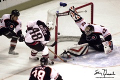Buffalo Sabres forward Daniel Briere(48) scores the first goal of the game on Philadelpia Flyers goaltender Robert Esche(42) while Flyer defenseman Kim Johnsson(5) and center Marty Murray Look on in Buffalo, New York march 18 2003. The Flyers are currently tied for first place in the Atlantic division with New Jersey. REUTERS/John Normile
